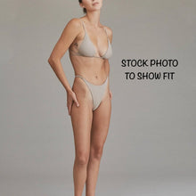Model wearing Acacia Ralphy Bikini Bottom to show high-cut fit and minimal coverage style.