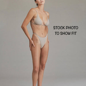 Model wearing Acacia Ralphy Bikini Bottom to show high-cut fit and minimal coverage style.