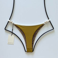 Back flat lay of Acacia Swimwear Neema Piped Ribbed Bikini Bottom in Miso brown with animal print lining.