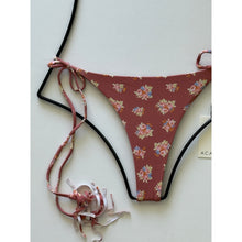 Close-up of Acacia Swimwear floral bikini bottom showing side ties and cheeky cut.