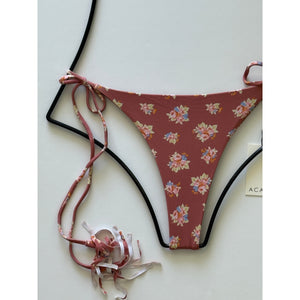 Close-up of Acacia Swimwear floral bikini bottom showing side ties and cheeky cut.