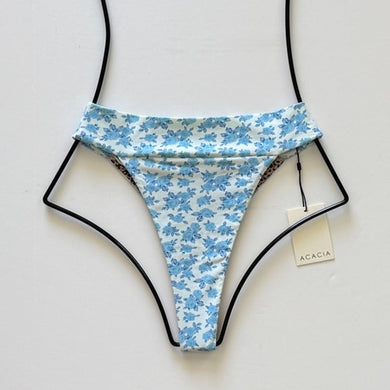 Flat lay of Acacia Swimwear Mateo Bikini Bottom in Petite Rose with ivory base and petite blue rose floral print, size Large.