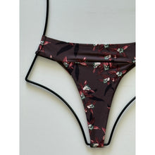 Close-up of waistband and floral detailing on the Acacia Mateo bikini bottom.
