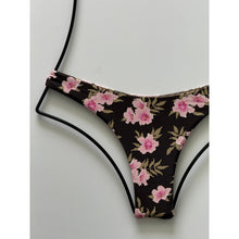 Close-up of Floret print showing pink hibiscus-style flowers and green leaves on a dark background.