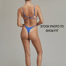 Model wearing Acacia Ralphy Bikini Bottom viewed from the back, showing cheeky minimal coverage fit.
