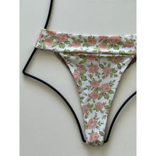 Close-up of Acacia Swimwear Mateo bikini bottom Rosie floral pattern with pink roses and green leaves on white base.