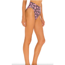 Model wearing Acacia Echo bikini bottom in Madonna print – high waist, cheeky cut with tropical floral print.