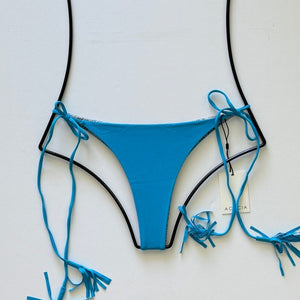 Flat lay of Acacia Swimwear Lauie ribbed bikini bottom in aqua blue Rocky’s color with tassel ties.