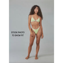 Stock photo of model wearing Acacia Swimwear Neema bottom (shown in another color for fit reference), high-leg cut and piped side detailing.