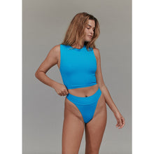 Model wearing Acacia Swimwear Mateo Ribbed Bikini Bottom in Rocky’s Blue, paired with matching top, front view.
