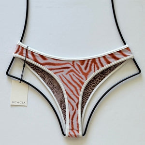 Back view of Flynn bottom with piped trim and animal print design.