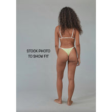 Stock photo – model wearing Acacia Swimwear Neema Piped Bikini Bottom in a similar style, back view to show fit.