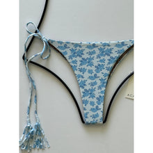 Close-up of Acacia Swimwear Lauie bikini bottom in Petite Rose floral pattern, showing details of side tie tassels.