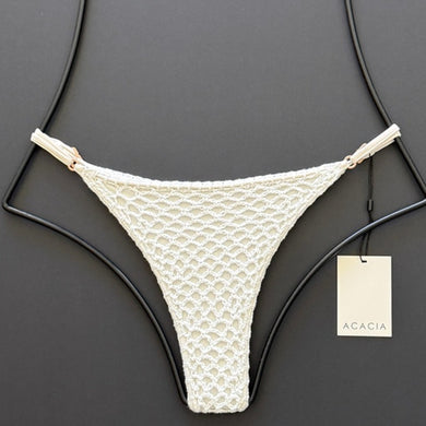 Flat lay front view of Acacia Swimwear Neema Crochet Bikini Bottom in Pikake white.