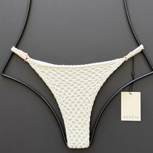 Flat lay front view of Acacia Swimwear Neema Crochet Bikini Bottom in Pikake white.