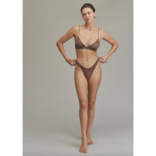 Model wearing Acacia Oslo Lining Bikini Bottom in Neutral Mares, high-cut leg and cheeky fit.