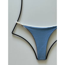 Close-up of dual ribbed blue fabric with contrast white piping detail.