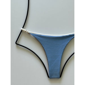 Close-up of dual ribbed blue fabric with contrast white piping detail.