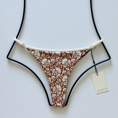 Flat lay of Acacia Swimwear Neema Piped Bikini Bottom in Autumn floral print, size Large