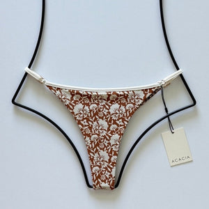 Flat lay of Acacia Swimwear Neema Piped Bikini Bottom in Autumn floral print, size Large