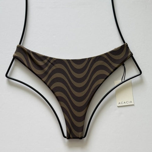 Flat lay of Acacia Swimwear Brazil Bikini Bottom in Jane brown wavy print.