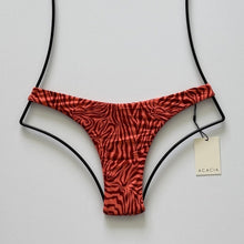 Front flat lay of Acacia Bodywear Oslo Lining Bikini Bottom in Neon Mares with coral zebra-inspired print.