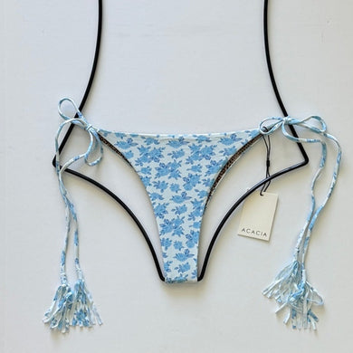 Light blue floral print Acacia Swimwear Lauie bikini bottom in Petite Rose with tassel side ties, displayed flat with brand tag.