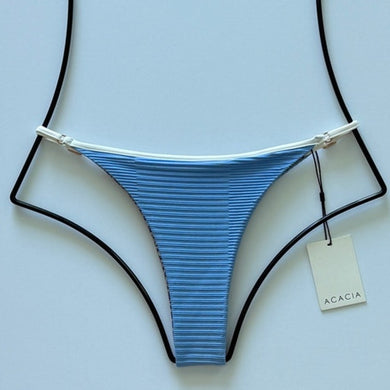 Flat lay of Acacia Swimwear Neema Piped Dual Ribbed Bikini Bottom in Seine blue with white trim, size large.
