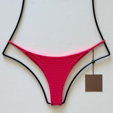 Flat lay of Acacia Swimwear Fins Mesh Bikini Bottom in bright Fruit Punch pink with textured mesh overlay, size small.