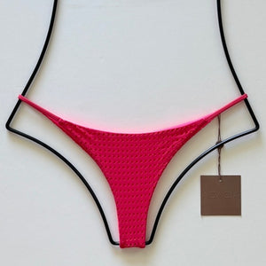 Flat lay of Acacia Swimwear Fins Mesh Bikini Bottom in bright Fruit Punch pink with textured mesh overlay, size small.