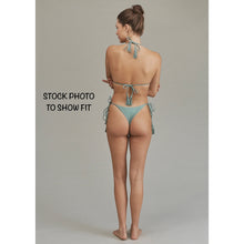 Back view of model in Acacia Swimwear Lauie bikini bottom, showing cheeky coverage and side-tie tassel details.