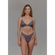 Model wearing Acacia Swimwear Brazil bottom in Burma print, styled as swimwear and lingerie