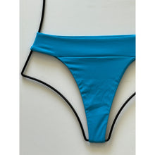Close-up detail of ribbed texture in bright blue fabric of the bikini bottom.