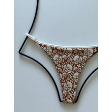 Close-up of Acacia Neema Autumn bikini bottom showing brown and cream floral pattern with piped trim