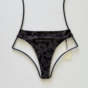 Flat lay of Acacia Swimwear Mateo Bikini Bottom in Taha’a, black with charcoal tropical floral print, size medium.