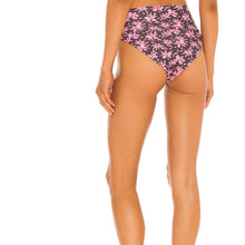 Model wearing Acacia Echo bikini bottom in Madonna print – high waist, cheeky cut with tropical floral print.