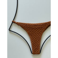 Close-up view showing crochet side detail and ribbed fabric texture of Acacia Swimwear Neema Crochet Bikini Bottom.