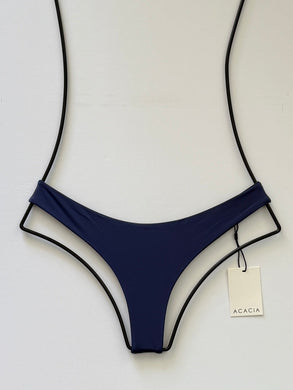 Front view of ACACIA Swimwear Ho‘okipa Bikini Bottom in Cobalt blue, low-rise cheeky Brazilian cut, skimpy coverage, flat lay with ACACIA tag.