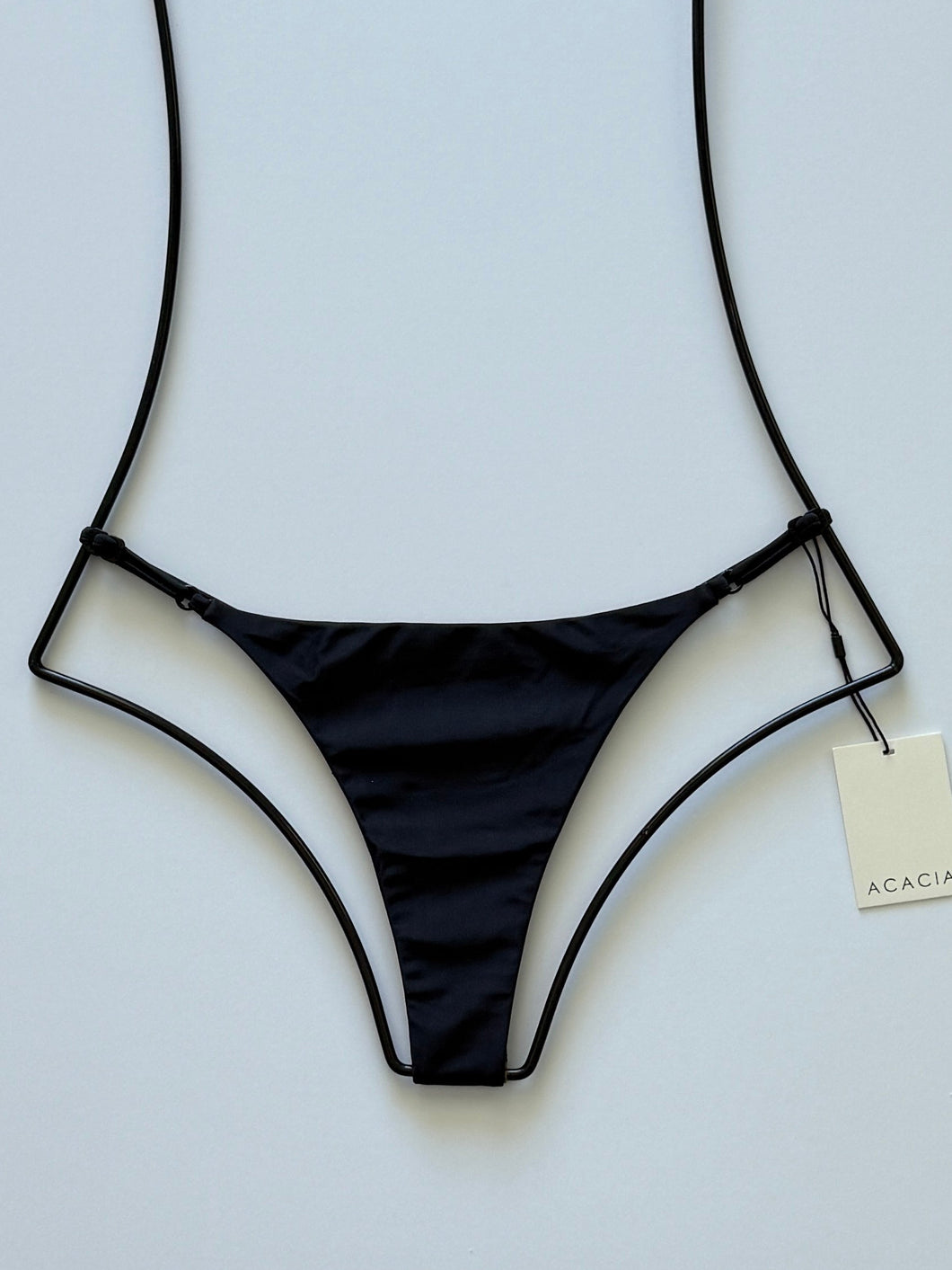 Front view of Acacia Ralphy Bikini Bottom in Licorice — solid black, high-cut minimal coverage swim bottom on display.