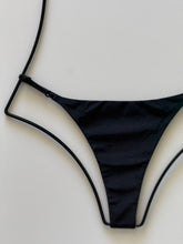 Close-up of Acacia Ralphy Bikini Bottom in Licorice showing smooth matte black fabric and side strap detail.