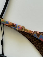 Detail of Acacia logo matte hardware on side strap of Mada zigzag bikini bottom.