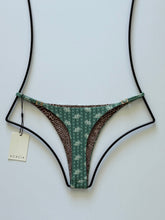 Back view of Acacia Ralphy Bikini Bottom showing floral and animal print contrast lining with matte hardware detail.