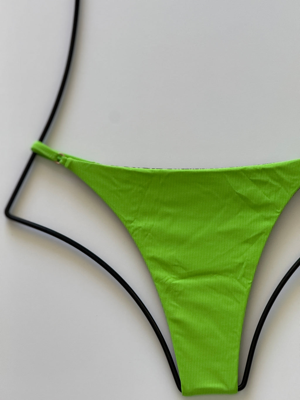 Close-up of ribbed Matcha green fabric texture on Acacia Ralphy Bikini Bottom.