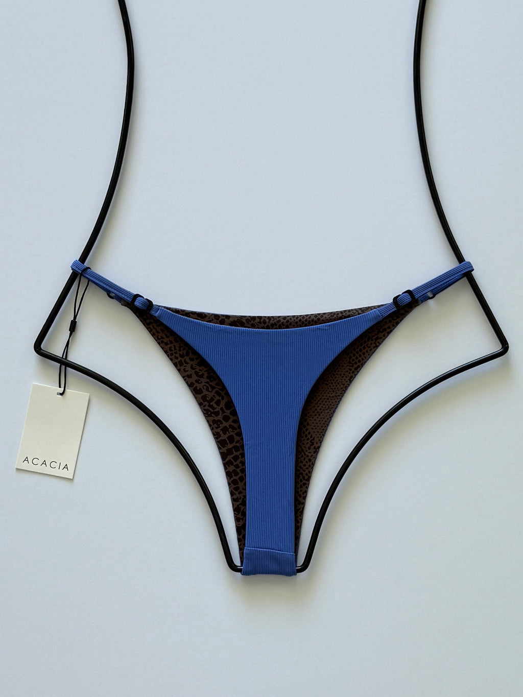 Back view of Acacia Ralphy Ribbed Bikini Bottom showing printed reverse and high-cut silhouette.