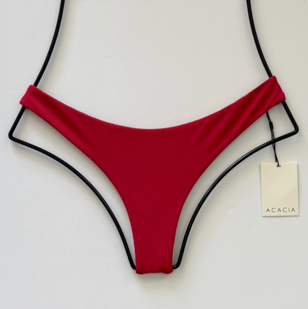 Acacia Swimwear Ho’okipa Ribbed Bikini Bottom in Sangria red, low-rise hipster cut with minimal Brazilian coverage, displayed flat with tag.