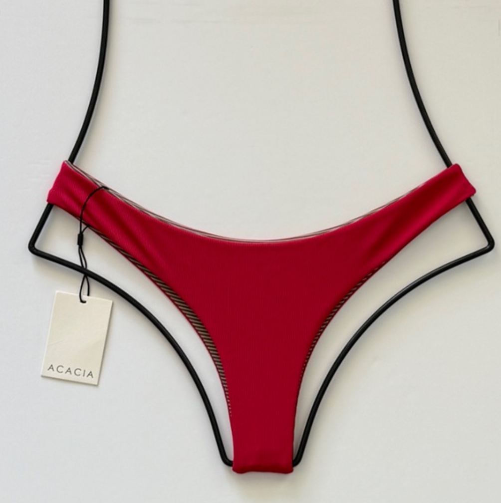 Acacia Ho’okipa ribbed bikini bottom in Sangria red shown flat with Acacia hang tag, cheeky minimal coverage swimwear.
