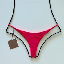 Flat lay of Acacia Swimwear Find Mesh Bikini Bottom in bright Fruit Punch pink with textured mesh overlay, size small.