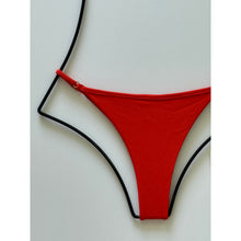 Close-up of ribbed Persimmon orange bikini bottom fabric and detailing.