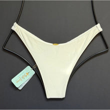 Ivory Brazilian cut bikini bottom by Luli Fama with minimal coverage and high-leg fit, shown flat with original tags.