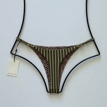 Reversible back of Acacia Ralphy bikini bottom featuring brown leopard print contrast with Acacia logo tag.